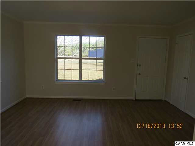 3934 Campbell Road Troy, VA 22974 - Photo 4 of 18 an empty room with wooden floor and windows
