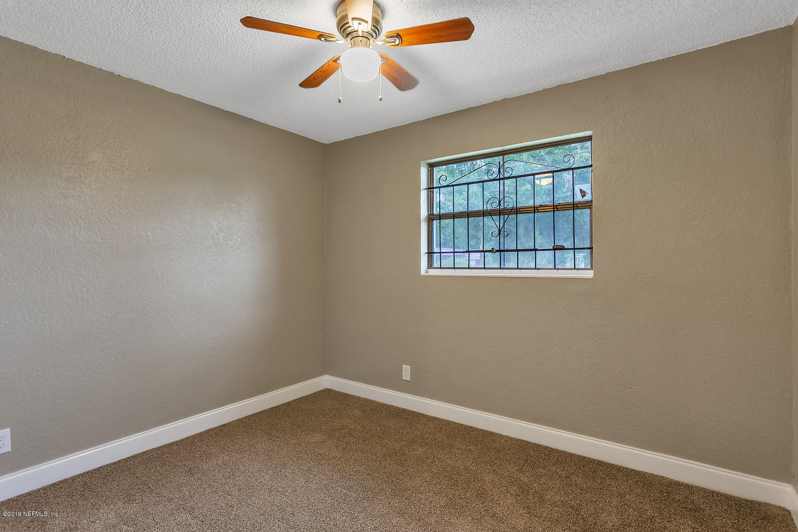 6718 Cavalier Road Jacksonville, FL 32208 - Photo 11 of 15 an empty room with a window
