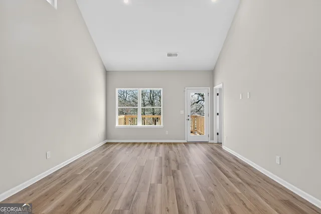 wooden floor in an empty room with a window