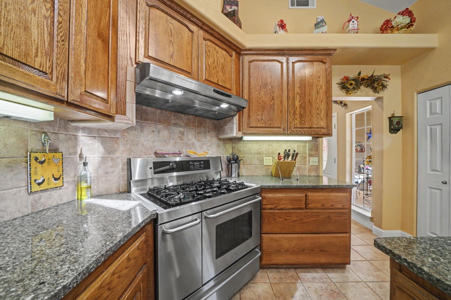 16111 Pioneer Creek Road Pioneer, CA 95666 - Photo 12 of 59 a kitchen with stainless steel appliances granite countertop a stove and a refrigerator