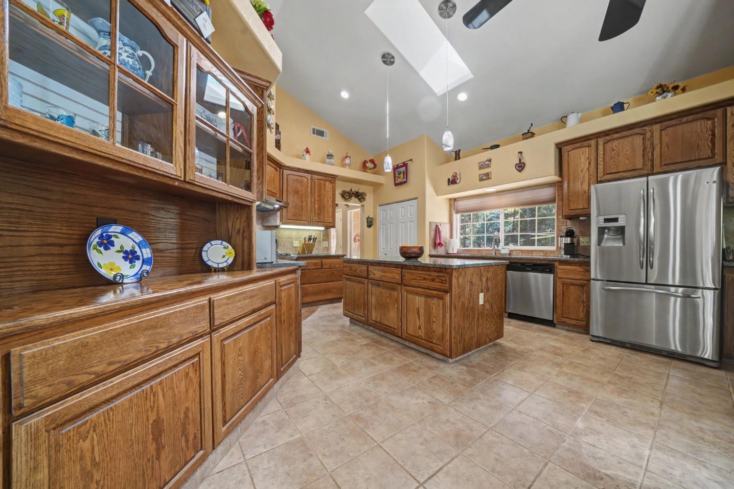 16111 Pioneer Creek Road Pioneer, CA 95666 - Photo 15 of 59 a kitchen with stainless steel appliances granite countertop a stove a refrigerator and a microwave