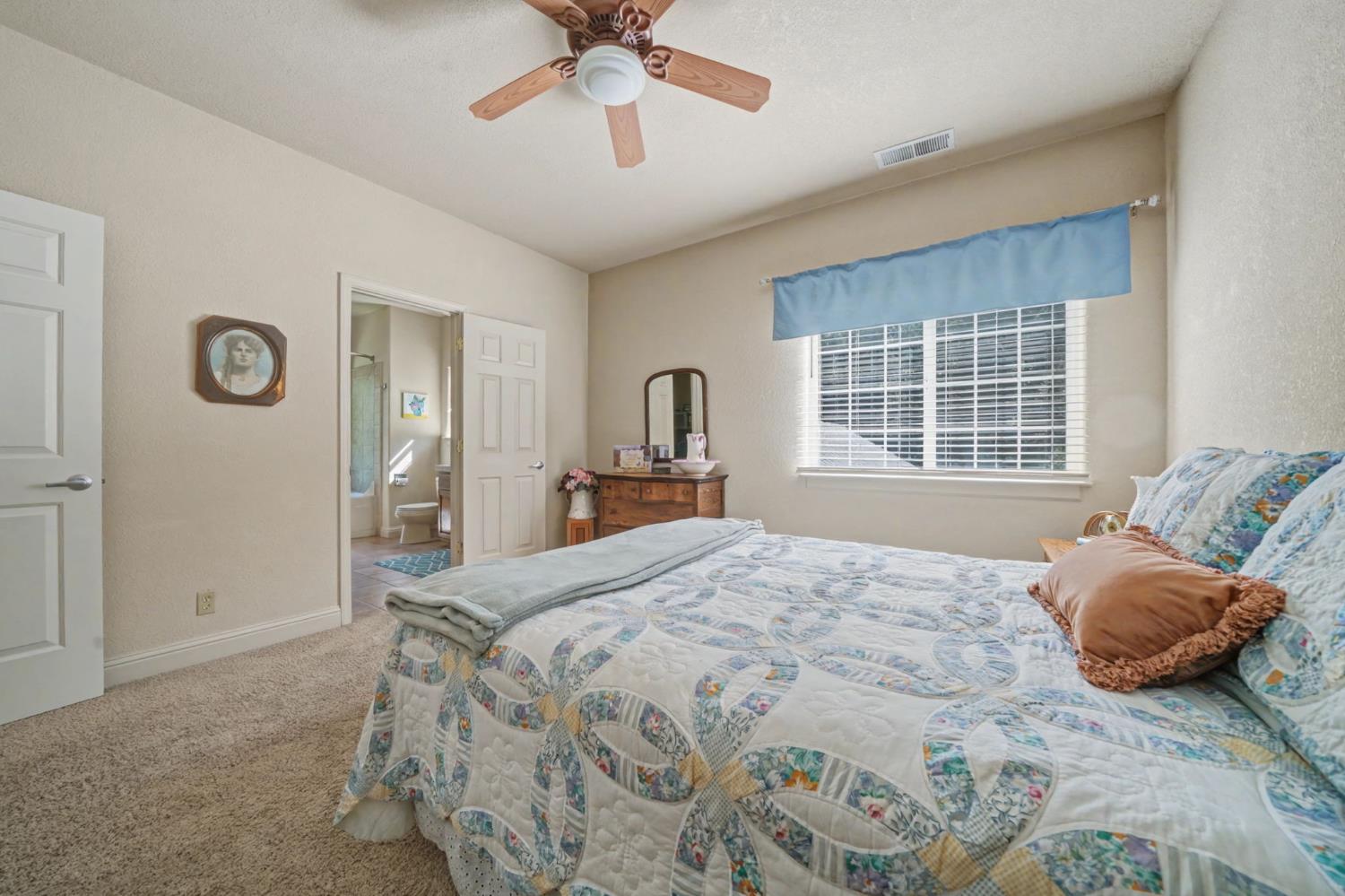 16111 Pioneer Creek Road Pioneer, CA 95666 - Photo 33 of 59 a bedroom with a bed and a chandelier