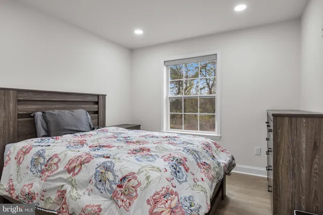 a bedroom with a large bed and a window