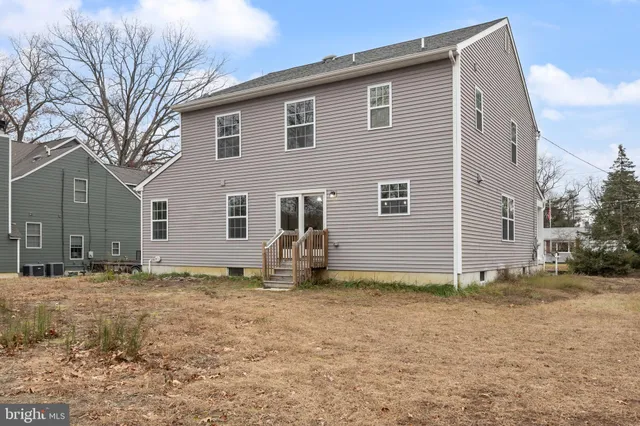 a front view of house with yard and trees