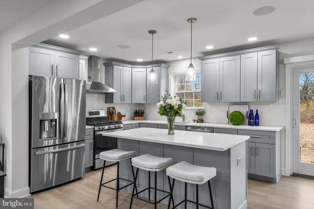 a kitchen with granite countertop a counter space stainless steel appliances and cabinets