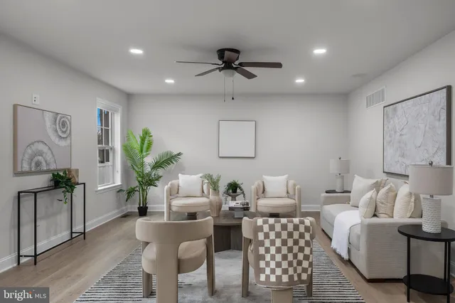 a living room with furniture or chandelier and a wooden floor