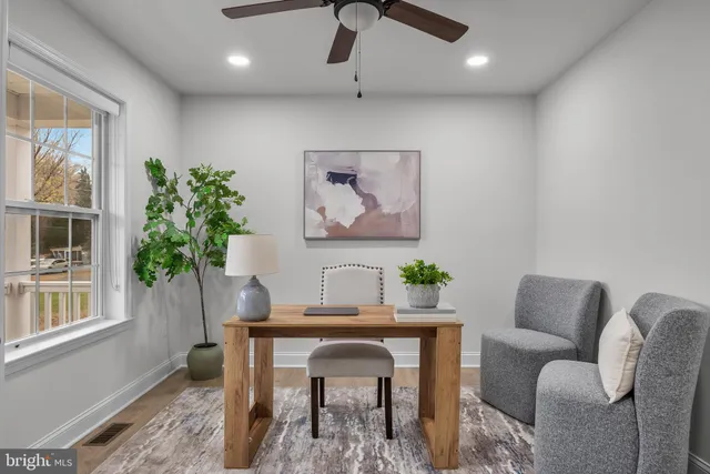 a workspace with furniture and a potted plant