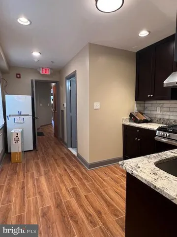 a kitchen with a sink and a stove top oven
