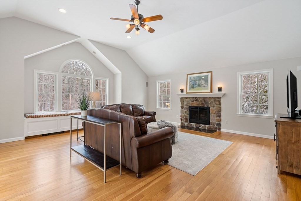 13 Jonathans Way Upton, MA 01568 - Photo 11 of 36 a living room with furniture a fireplace and a large window
