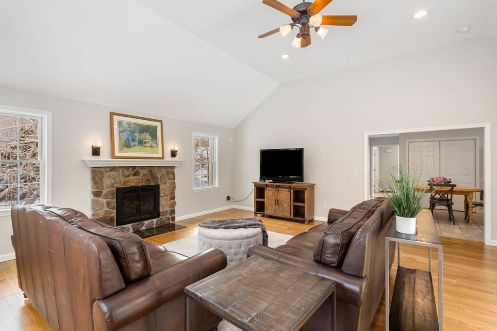 13 Jonathans Way Upton, MA 01568 - Photo 13 of 36 a living room with furniture a fireplace and a flat screen tv