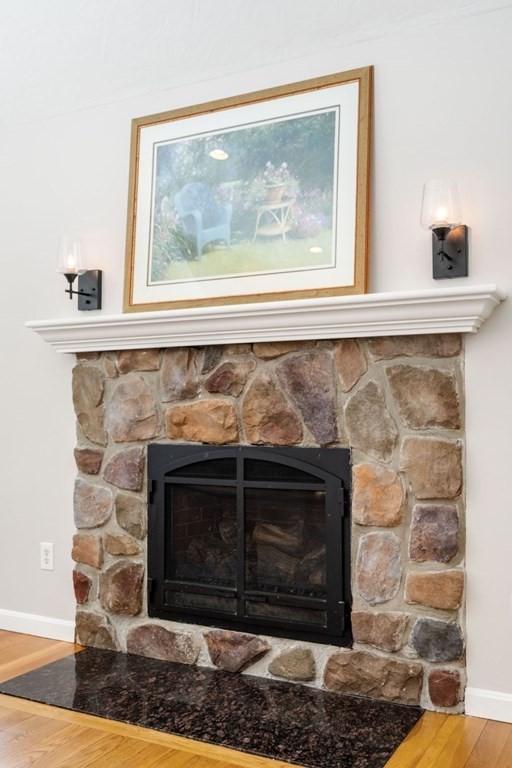13 Jonathans Way Upton, MA 01568 - Photo 14 of 36 a fireplace with a clock on top of it