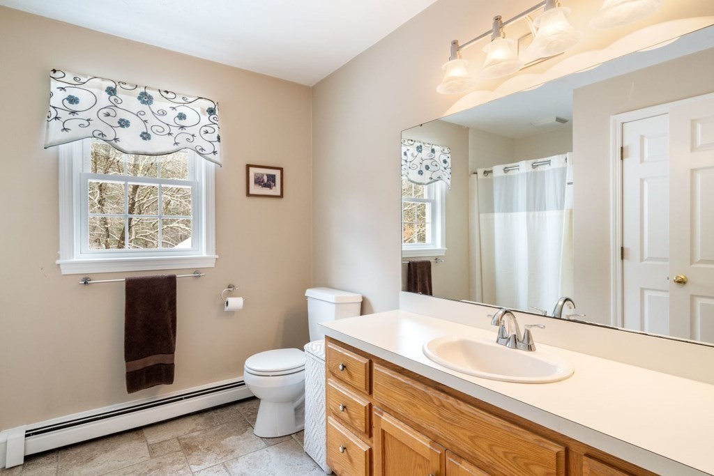 13 Jonathans Way Upton, MA 01568 - Photo 19 of 36 a bathroom with a toilet sink and mirror