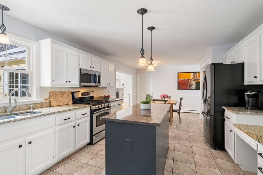 13 Jonathans Way Upton, MA 01568 - Photo 7 of 36 a kitchen with stainless steel appliances granite countertop a sink a stove top oven a granite counter space and cabinets