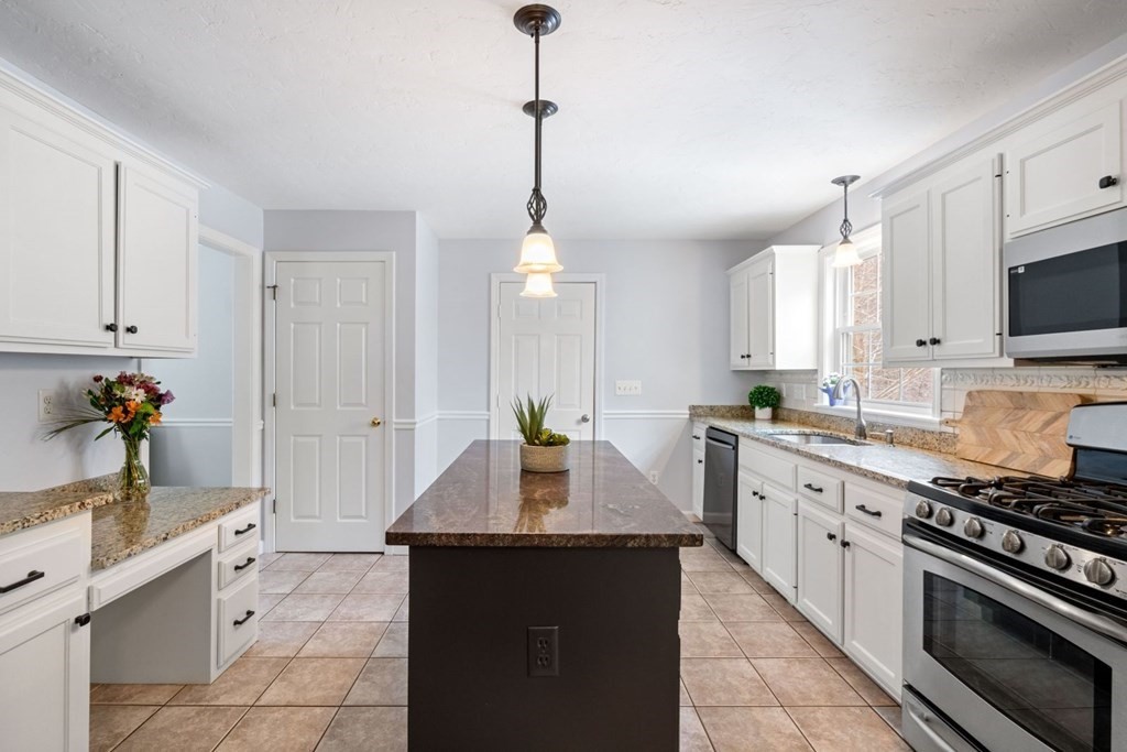 13 Jonathans Way Upton, MA 01568 - Photo 8 of 36 a kitchen with stainless steel appliances a sink stove and refrigerator
