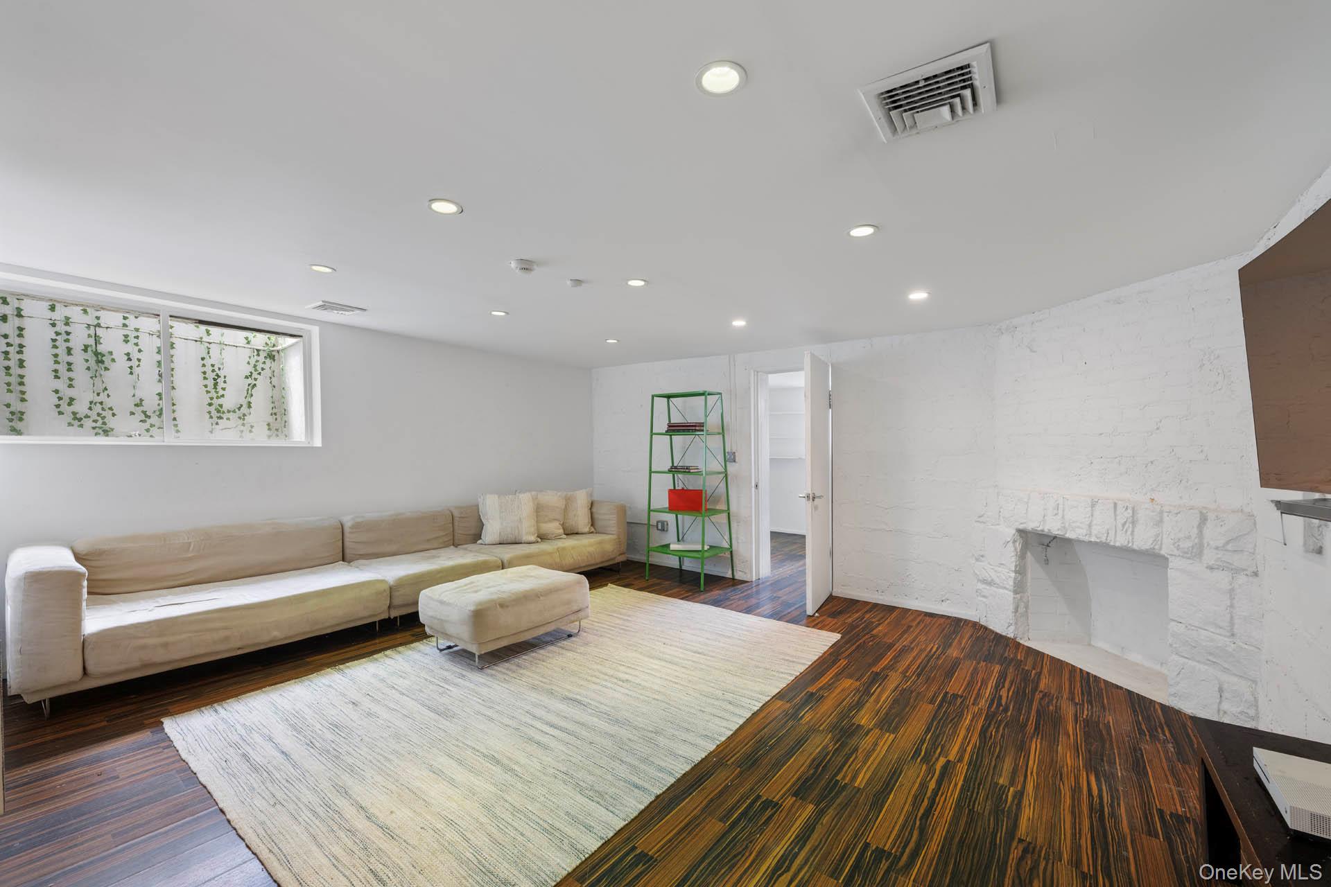 800 West 231st Street Bronx, NY 10463 - Photo 17 of 36 a bedroom with furniture and a wooden floor