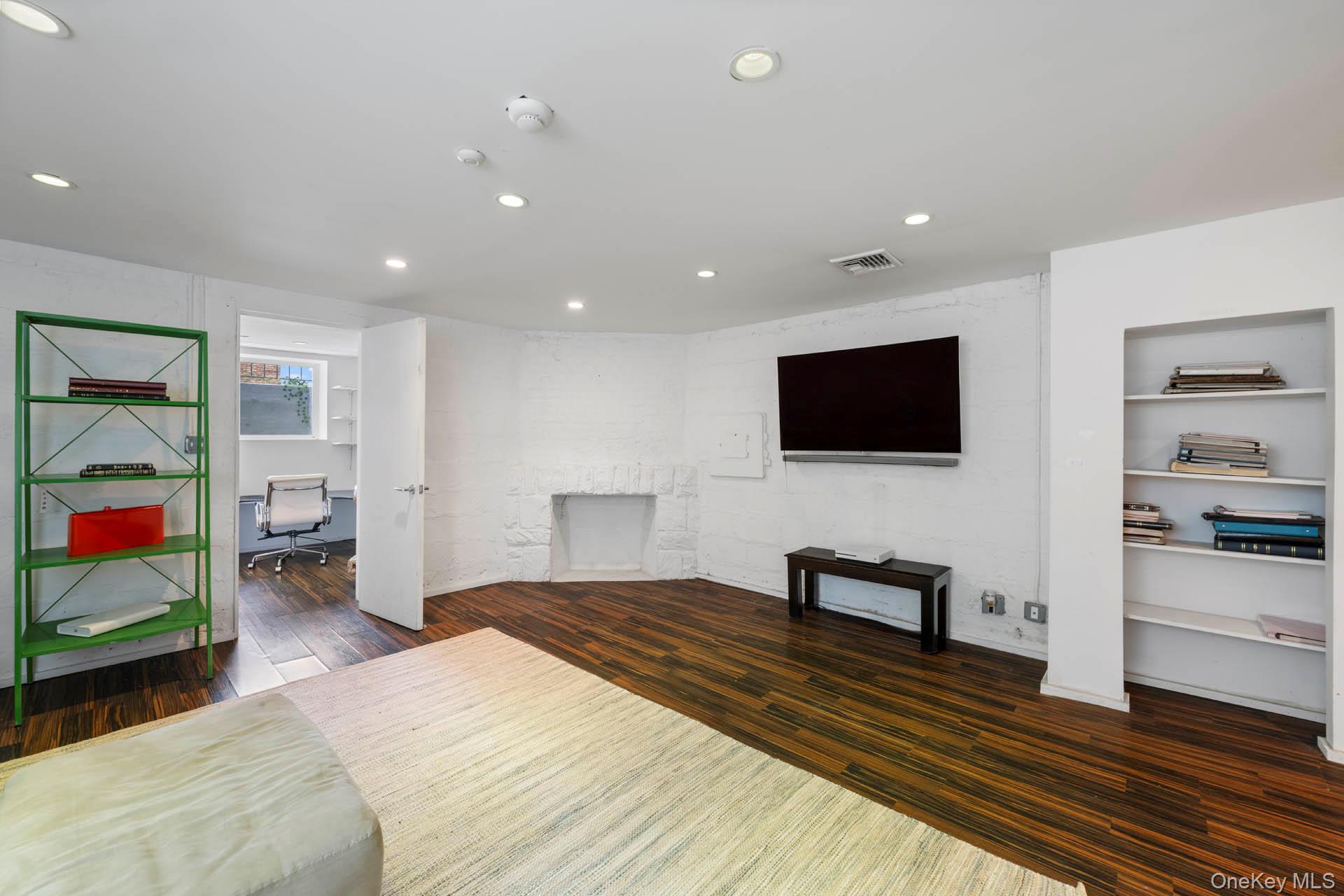 800 West 231st Street Bronx, NY 10463 - Photo 18 of 36 a bedroom with furniture and a flat screen tv