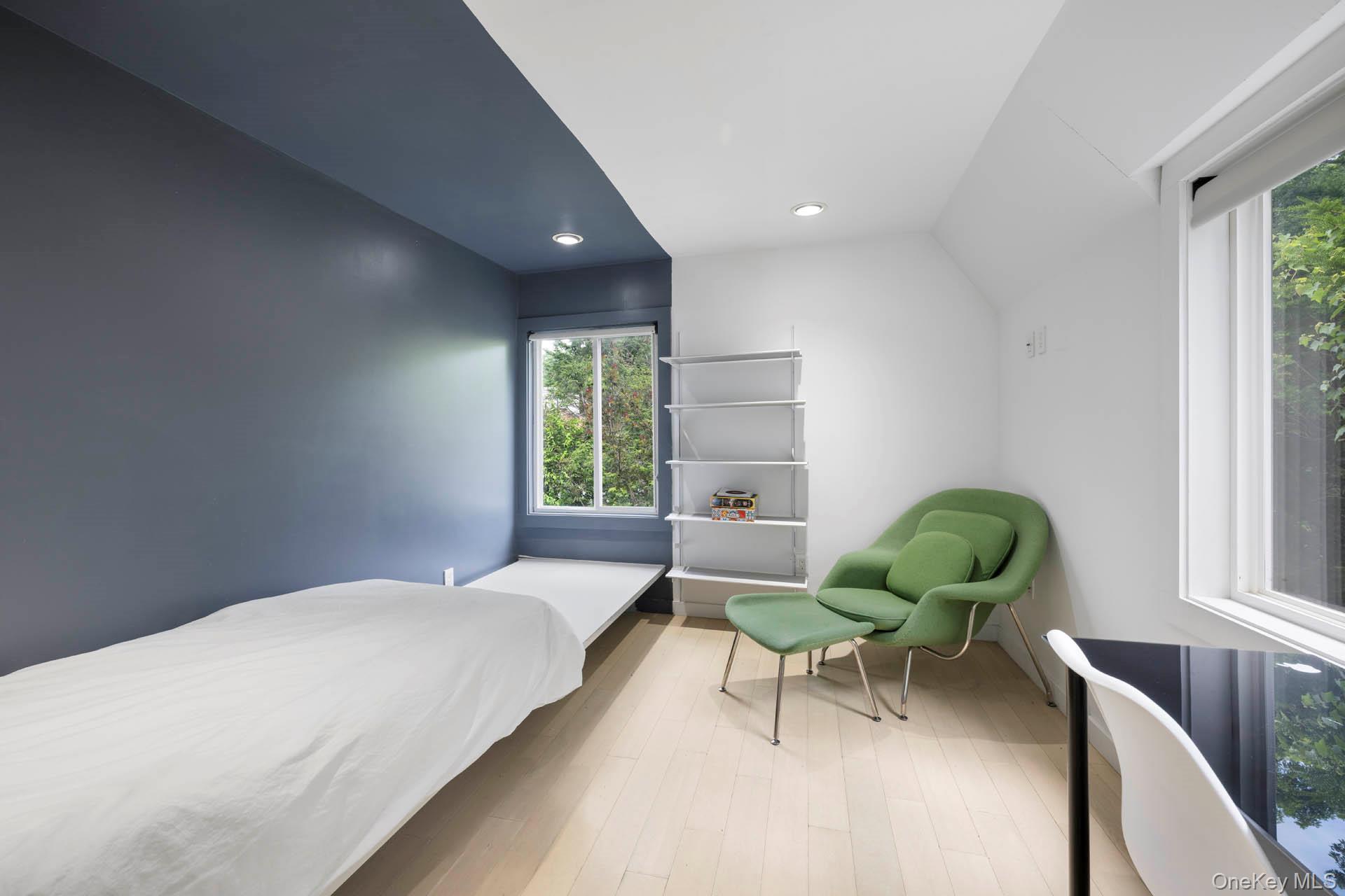 800 West 231st Street Bronx, NY 10463 - Photo 19 of 36 a bedroom with a bed a chair and a window