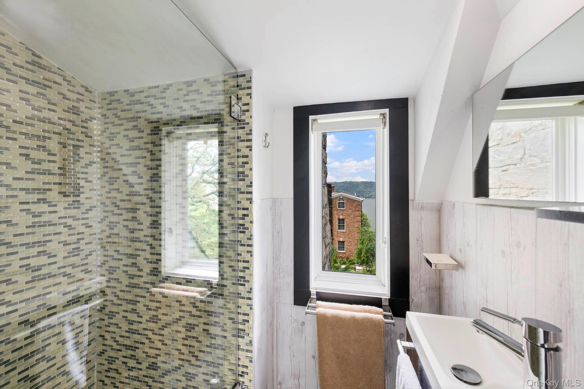 800 West 231st Street Bronx, NY 10463 - Photo 23 of 36 a bathroom with a tub and a window