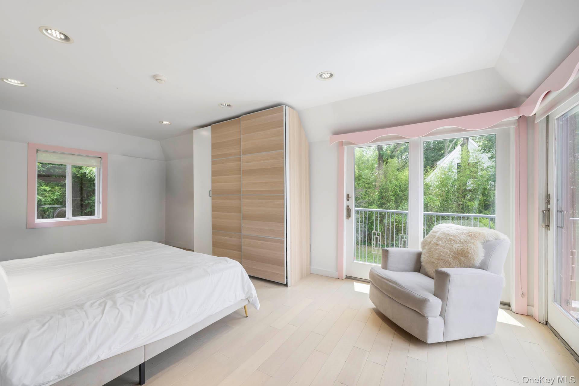 800 West 231st Street Bronx, NY 10463 - Photo 25 of 36 a spacious bedroom with a bed and a couch next to a window