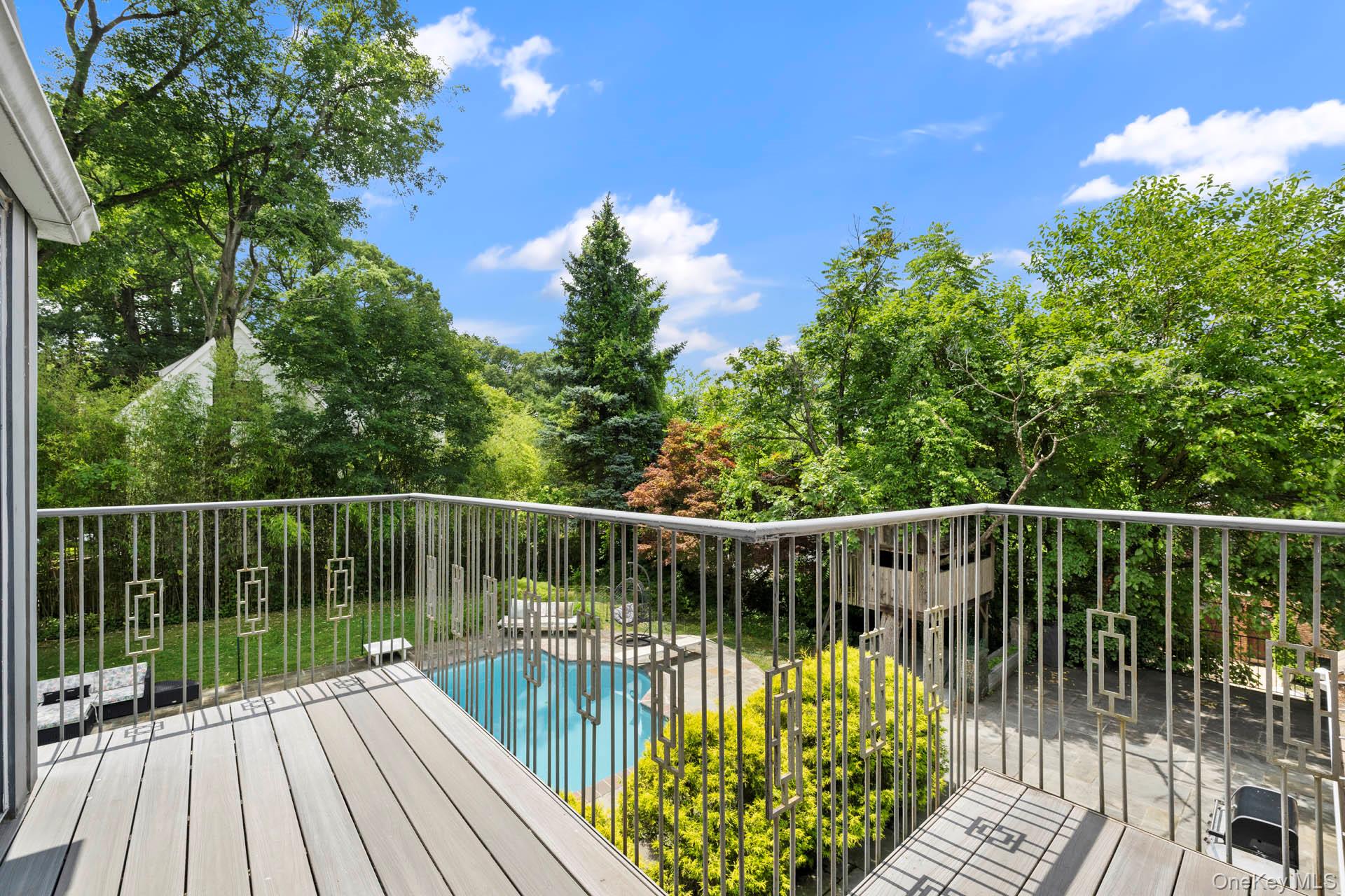 800 West 231st Street Bronx, NY 10463 - Photo 27 of 36 a view of balcony with two large trees and wooden fence
