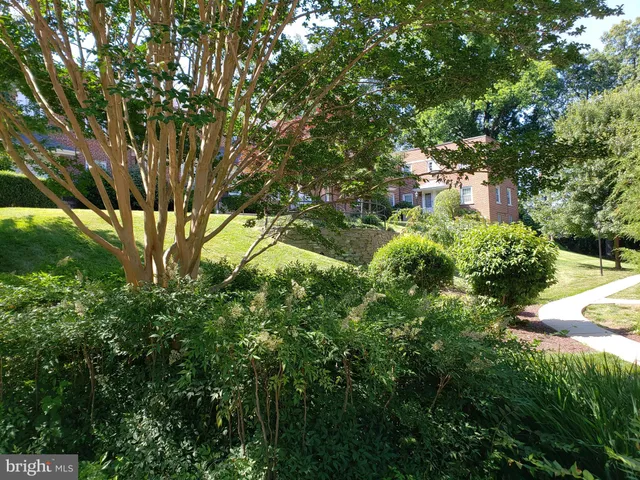 a backyard of a house with lots of green space and garden
