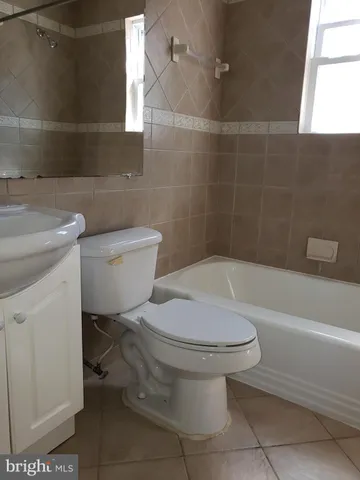 a bathroom with a toilet and a bathtub