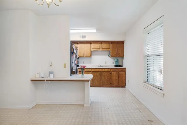 a kitchen with stainless steel appliances granite countertop a sink and a stove