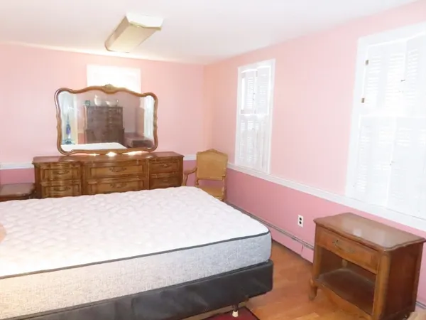 a bedroom with a bed and lamp