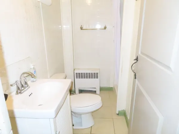 a bathroom with a sink a toilet and a mirror
