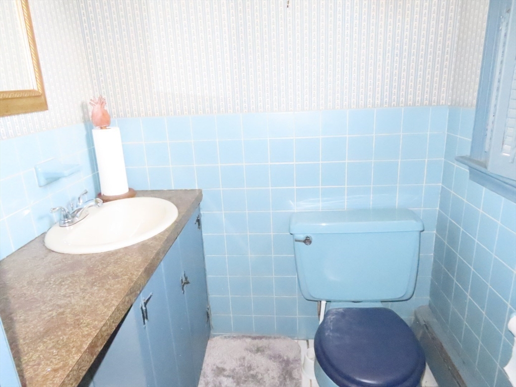 268 Main Street Dennis, MA 02660 - Photo 18 of 21 a bathroom with a sink a toilet and a mirror