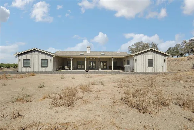 a kitchen with stainless steel appliances kitchen island granite countertop a stove a sink dishwasher and a refrigerator with wooden floor