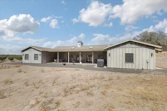a kitchen with stainless steel appliances granite countertop a sink a stove and cabinets