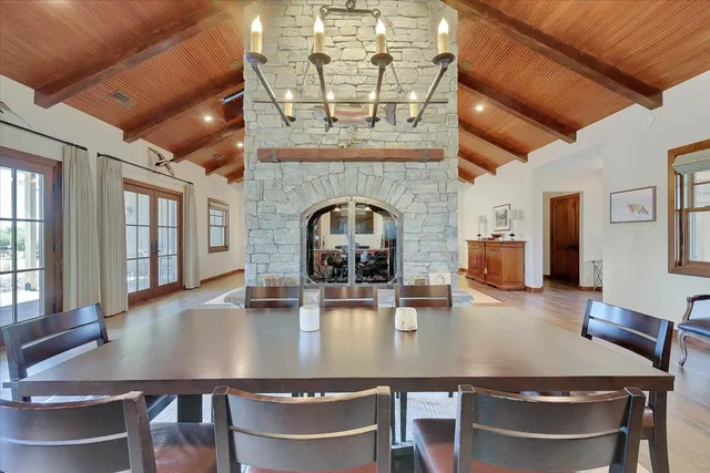 a kitchen with stainless steel appliances granite countertop a sink and cabinets with wooden floor