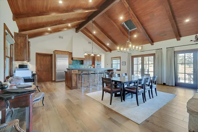 a bedroom with two beds and a chandelier
