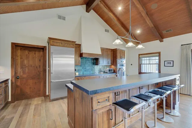 a bathroom with a toilet a sink a vanity and mirror