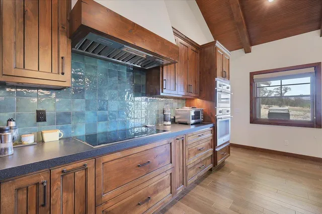 a bathroom with a granite countertop sink a toilet and a bathtub
