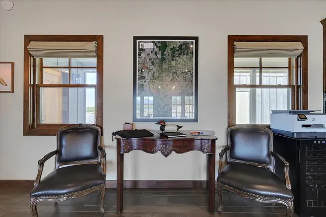 a living room with furniture a flat screen tv and kitchen view