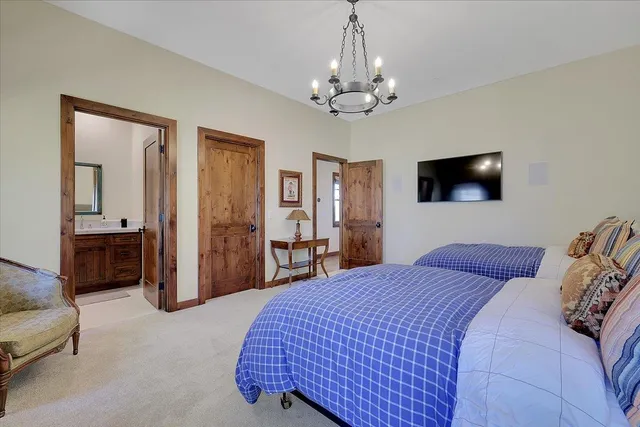 a living room with furniture a chandelier and a fireplace