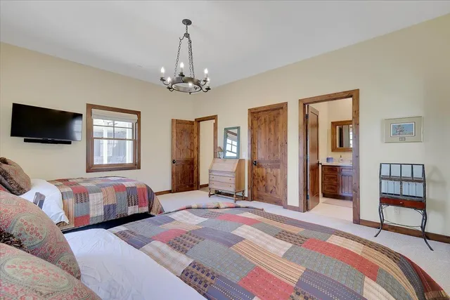 a bathroom with a granite countertop toilet sink and mirror