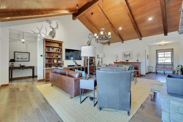 a spacious bedroom with a bed and a chandelier