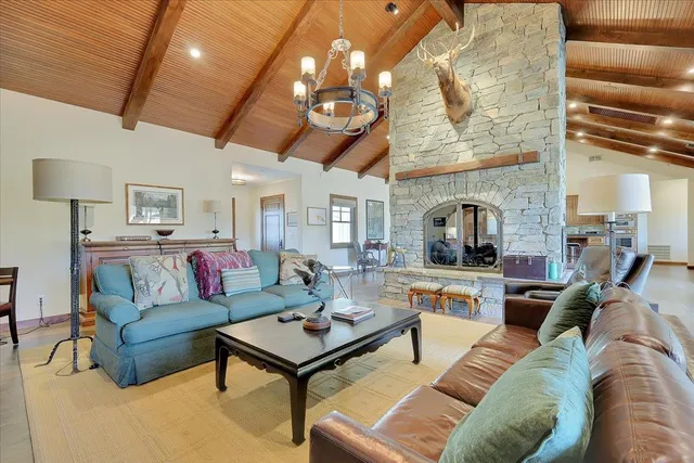 a living room with furniture and a floor to ceiling window