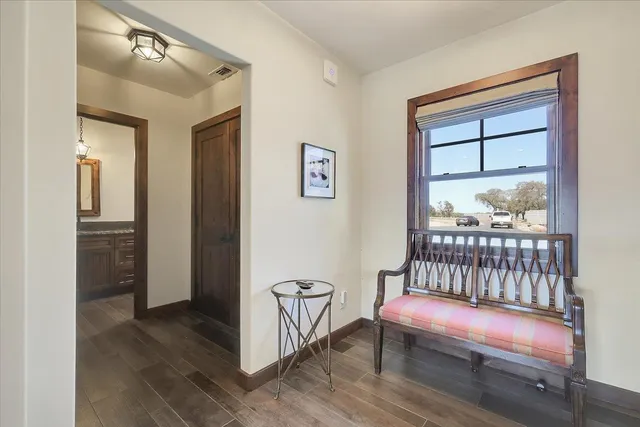 a view of a workspace with furniture and a window