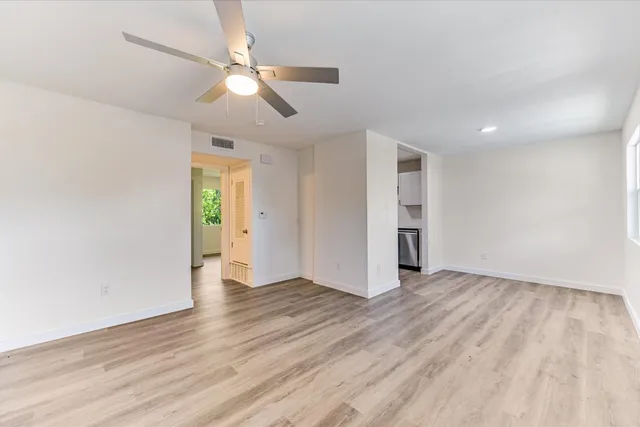 wooden floor in an empty room with a window