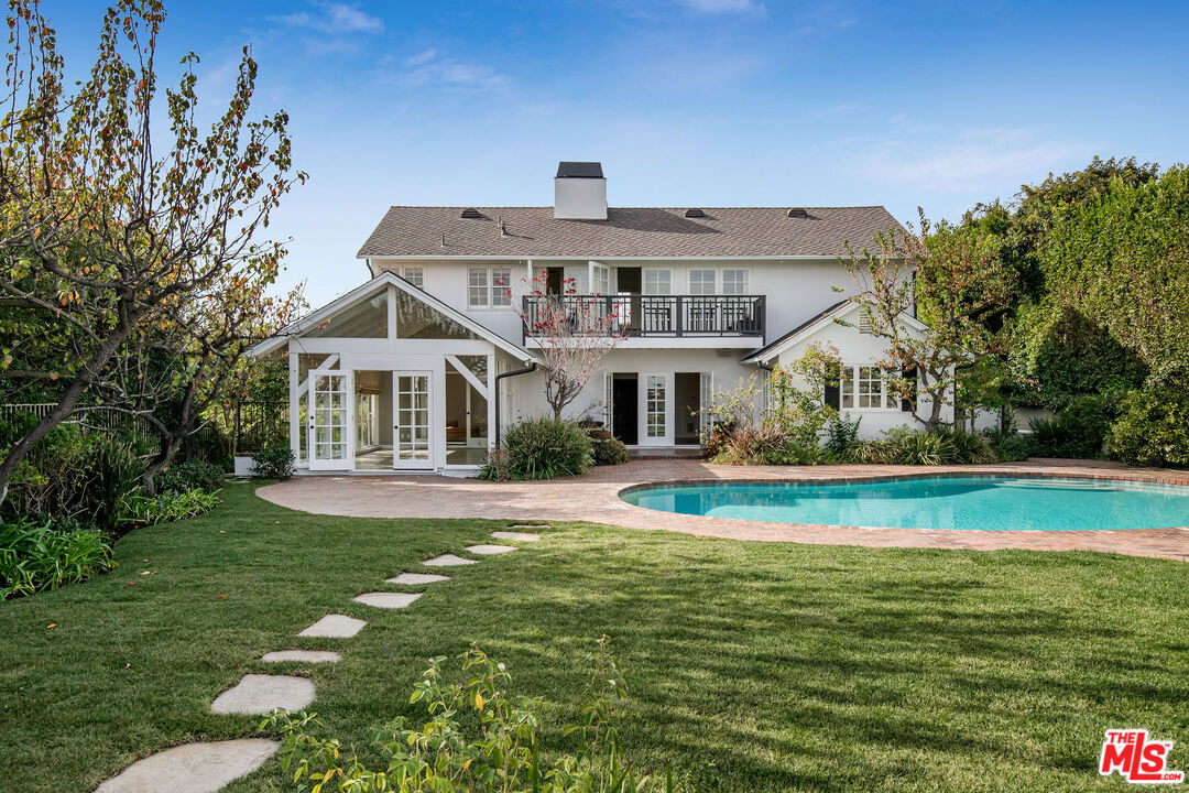 1110 Stradella Road Los Angeles, CA 90077 - Photo 1 of 26 a front view of a house with swimming pool having outdoor seating