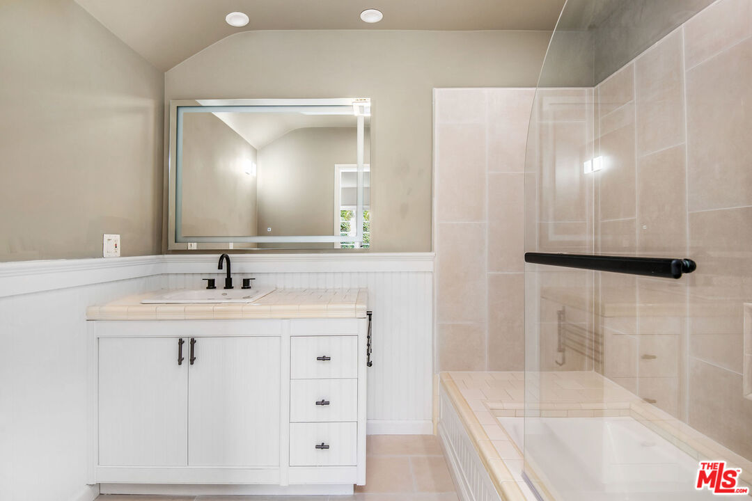 1110 Stradella Road Los Angeles, CA 90077 - Photo 16 of 26 a bathroom with a sink and a mirror