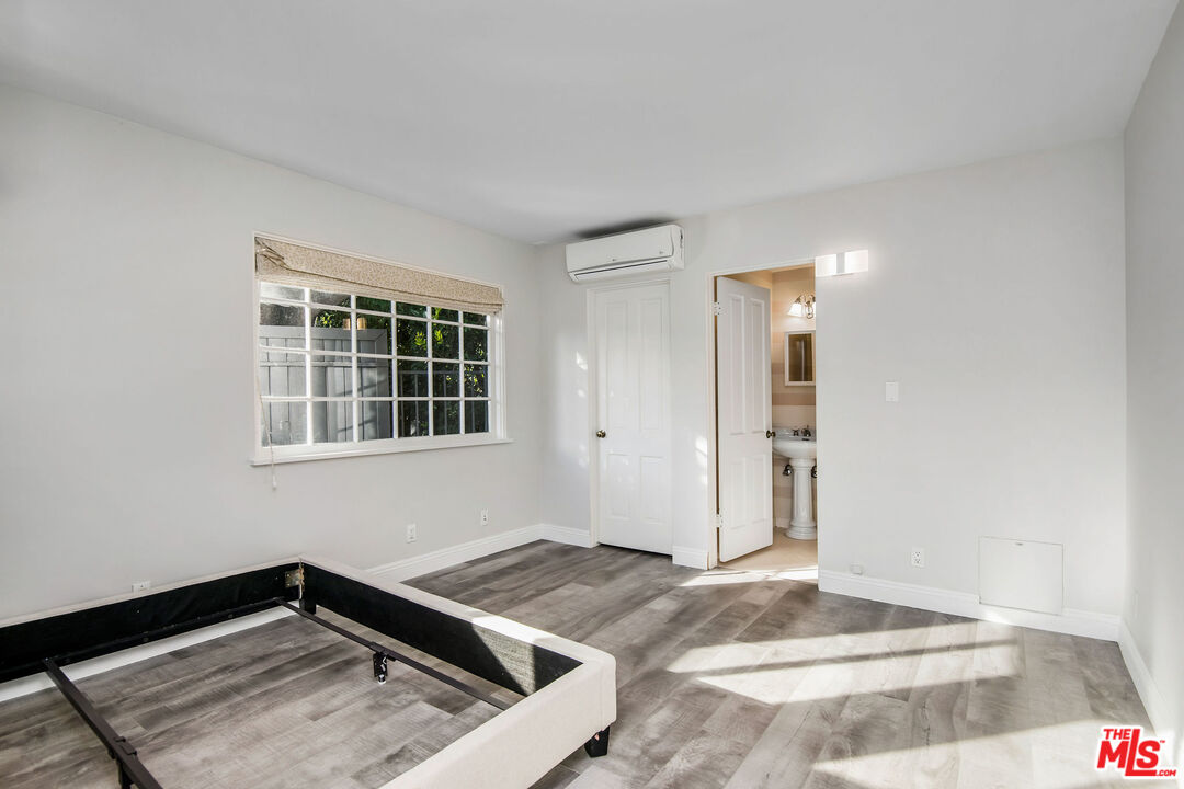 1110 Stradella Road Los Angeles, CA 90077 - Photo 18 of 26 a view of a livingroom with wooden floor and a window