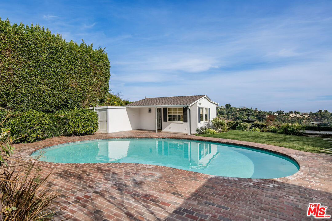 1110 Stradella Road Los Angeles, CA 90077 - Photo 19 of 26 a view of a house with a yard