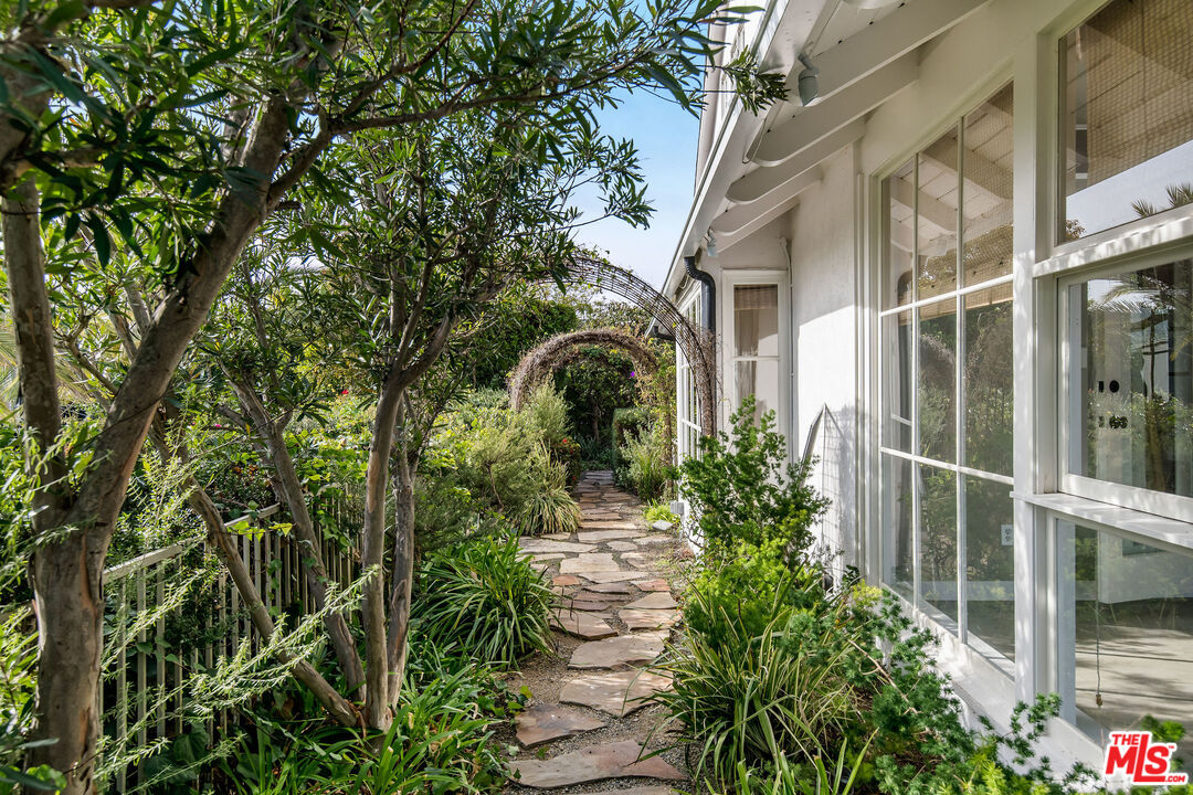 1110 Stradella Road Los Angeles, CA 90077 - Photo 21 of 26 a front view of a house with garden