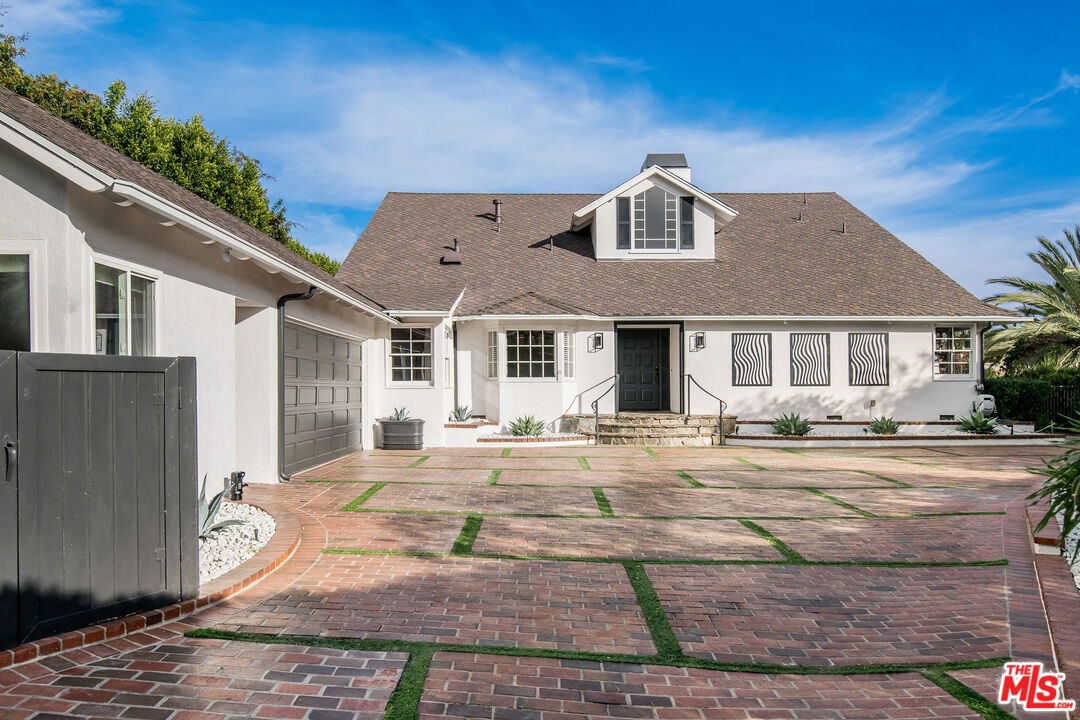 1110 Stradella Road Los Angeles, CA 90077 - Photo 26 of 26 front view of a house with a yard