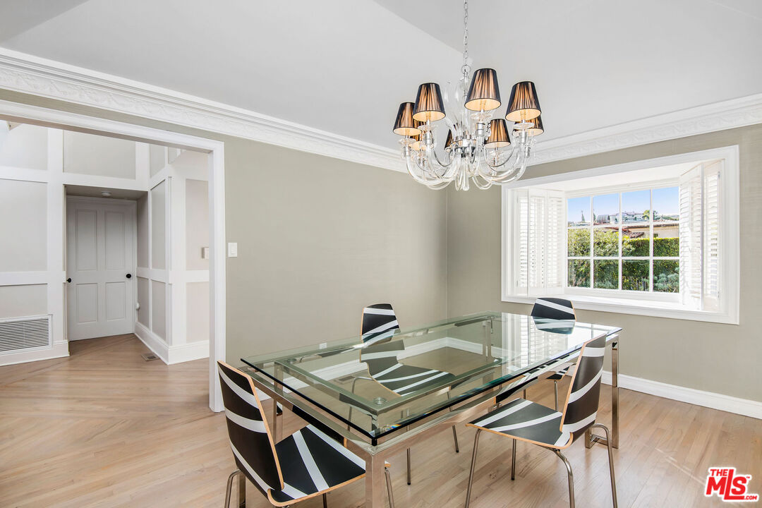 1110 Stradella Road Los Angeles, CA 90077 - Photo 7 of 26 a view of a dining room with a table and chairs